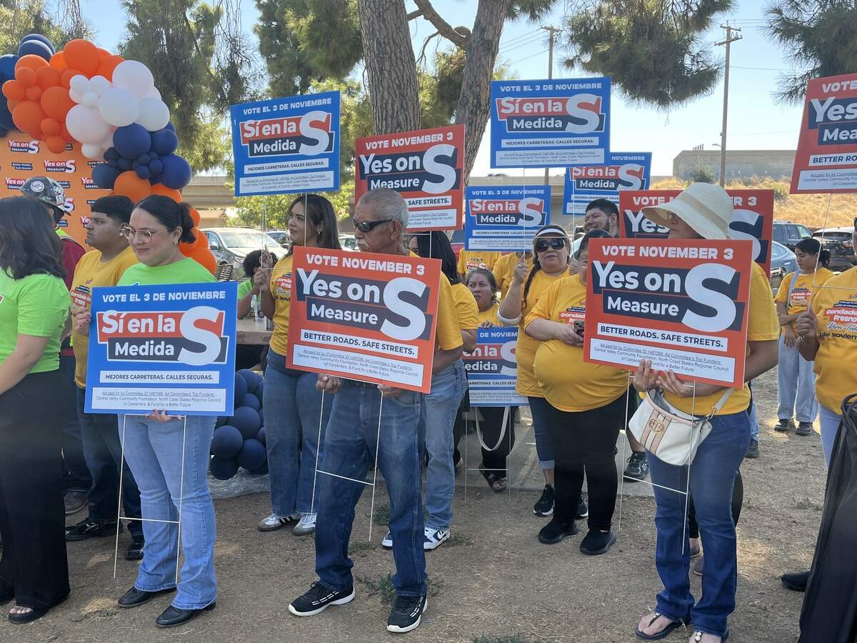 Measure S supporters hold signs at the campaign kickoff news conference at Vinland Park in Fresno on Sept. 9, 2026.